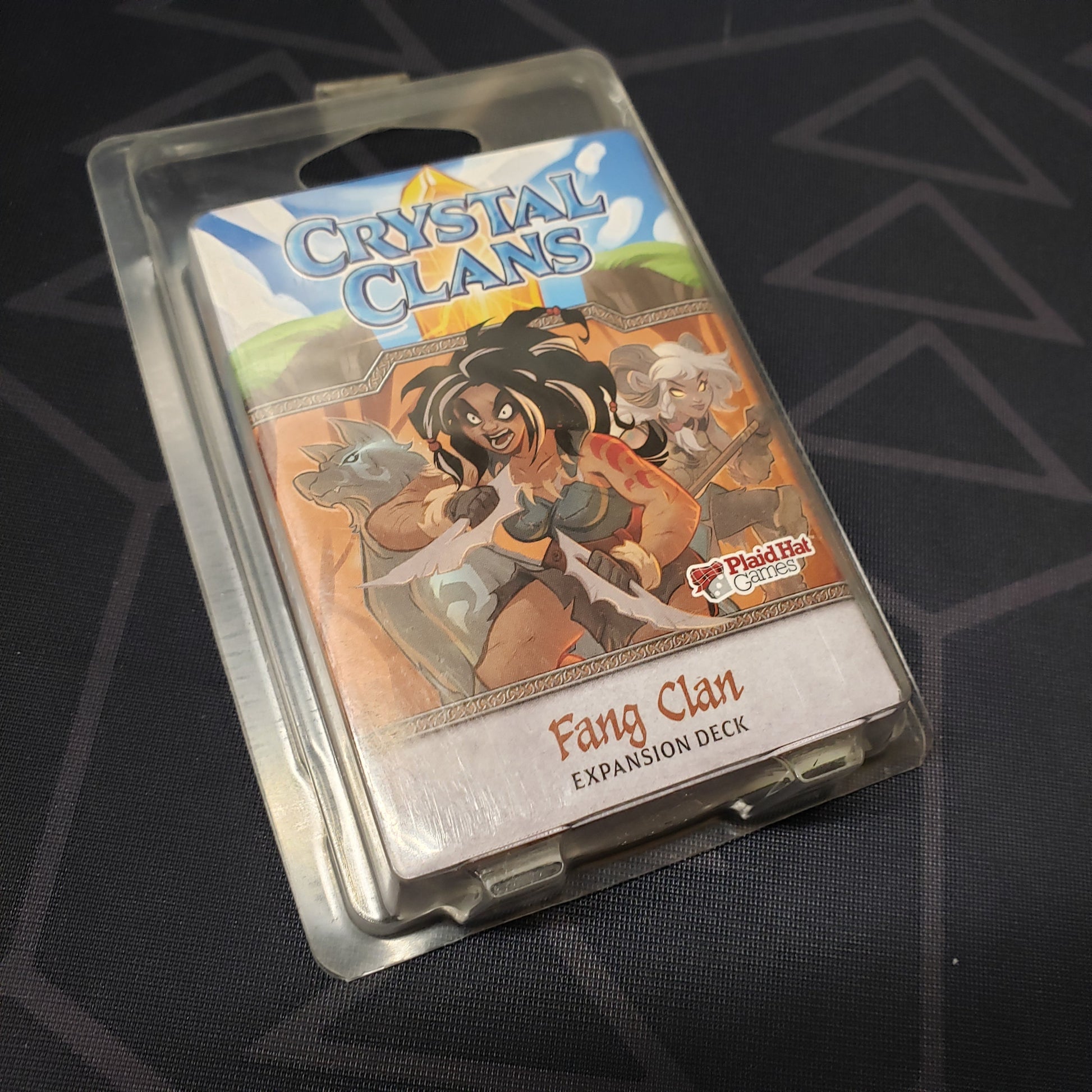 Image shows the front of the package of the Fang Clan expansion for the card game Crystal Clans
