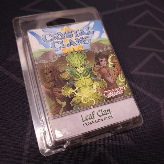 Image shows the front of the package of the Leaf Clan expansion for the card game Crystal Clans