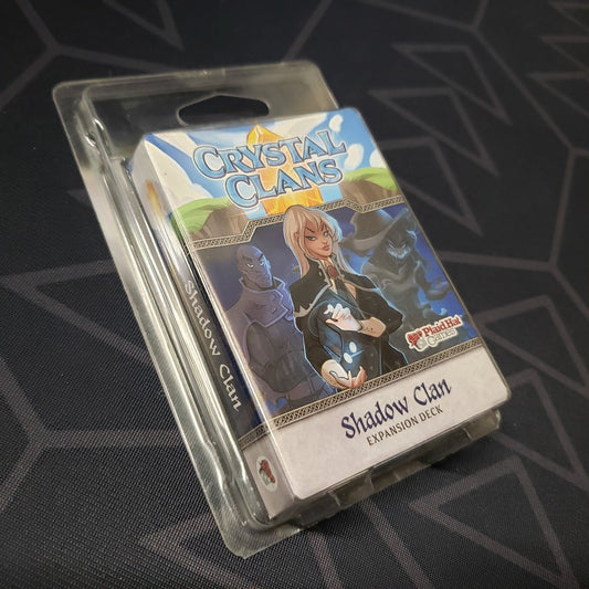Image shows the front of the package of the Shadow Clan expansion for the card game Crystal Clans