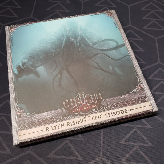 Image shows the front cover of the box of the R'lyeh Rising expansion for the board game Cthulhu: Death May Die