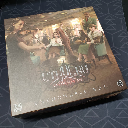 Image shows the front cover of the box of the Unknowable Box expansion for the board game Cthulhu: Death May Die