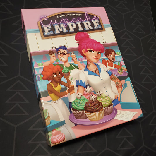 Image shows the front cover of the box for the Cupcake Empire board game