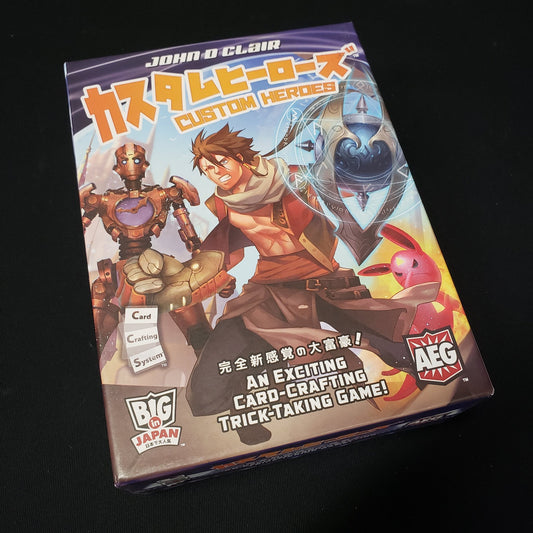 Image shows the front cover of the box of the Custom Heroes card game