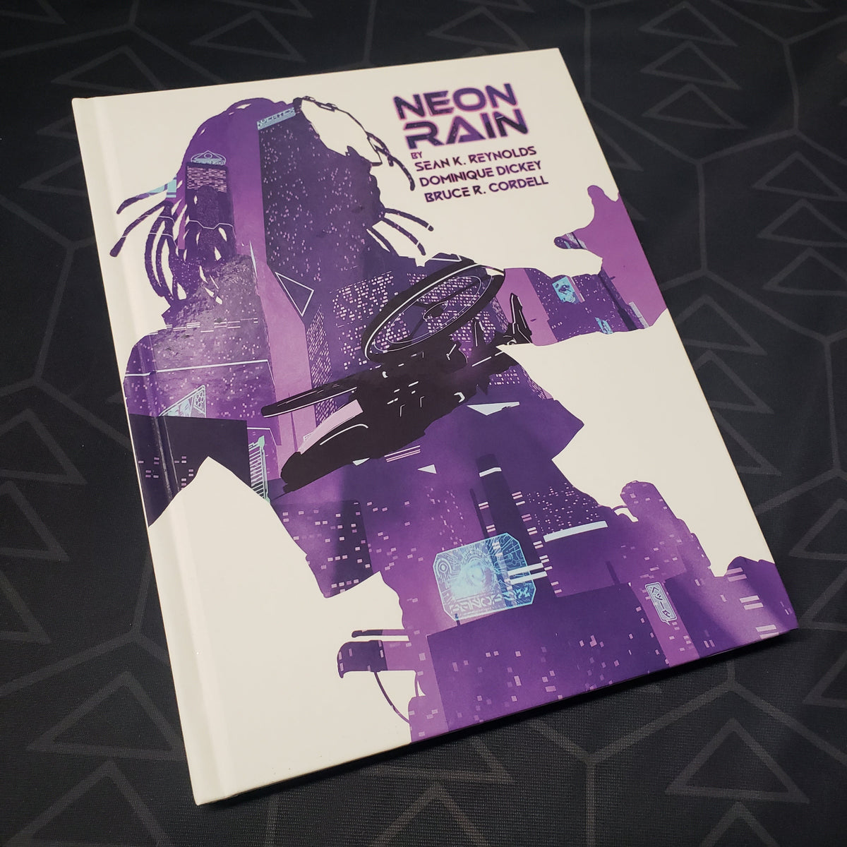 Image shows the front cover of the Neon Rain book for the Cypher System roleplaying game