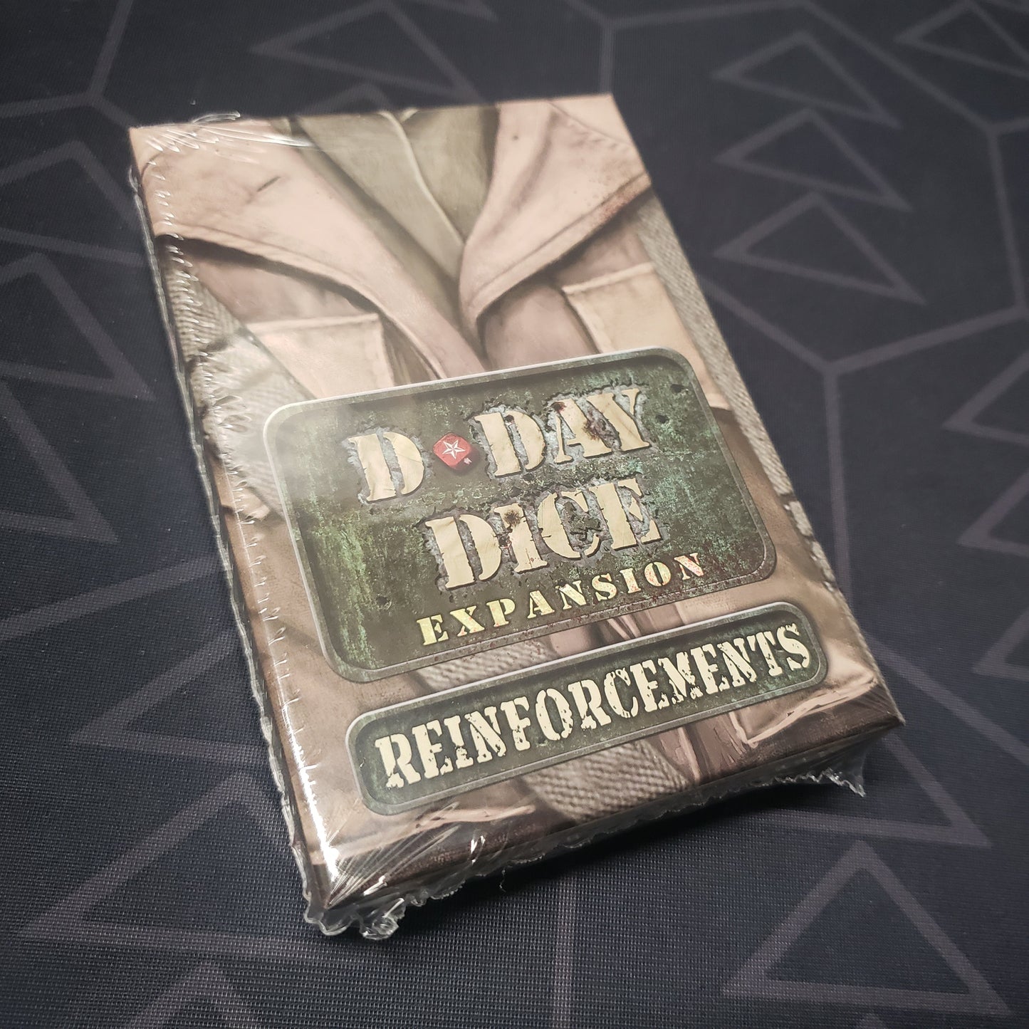 Image shows the front cover of the box of the Reinforcements expansion for the board game D-Day Dice (Second Edition)