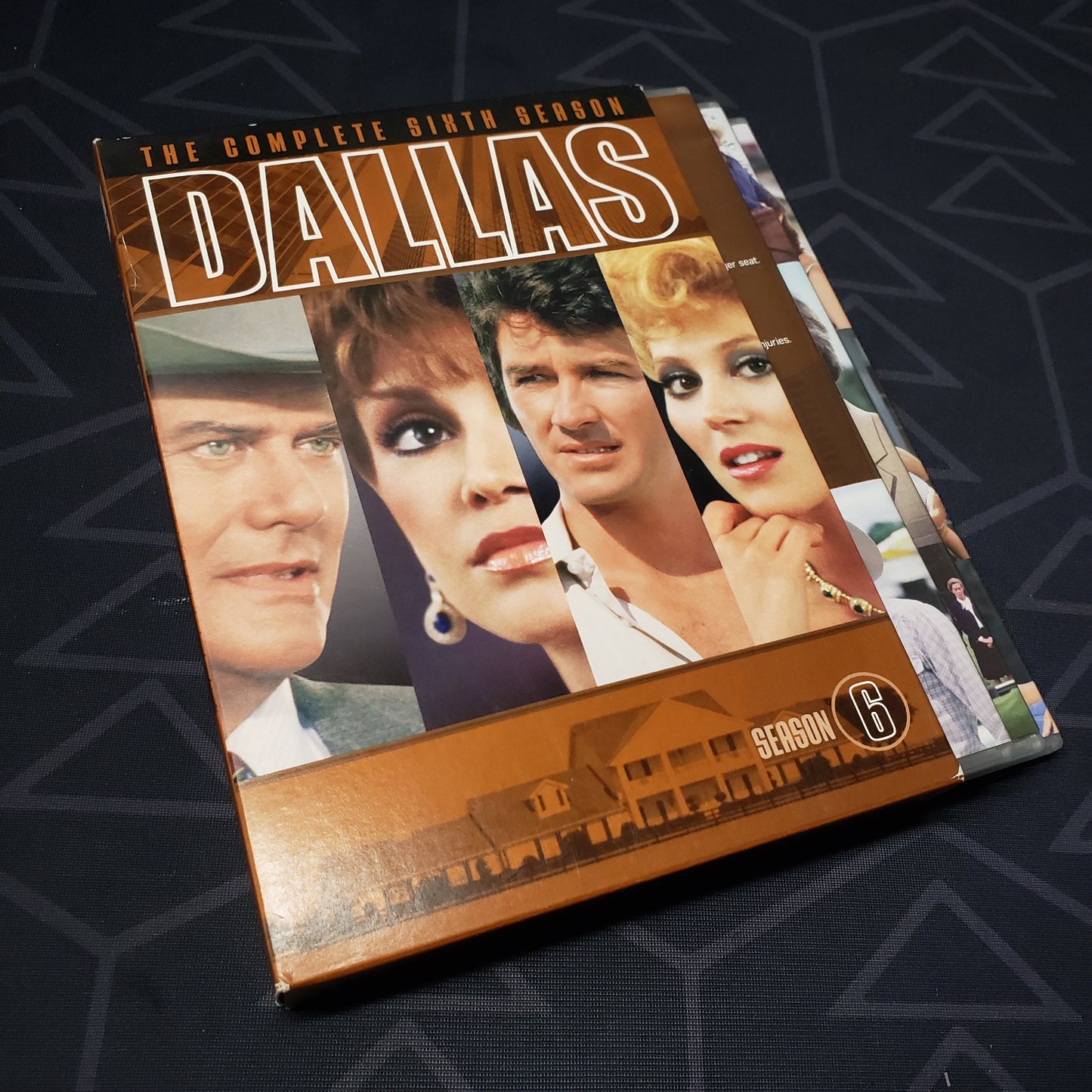 Image shows the outer box & three fanned-out disc cases for the sixth season of Dallas on DVD