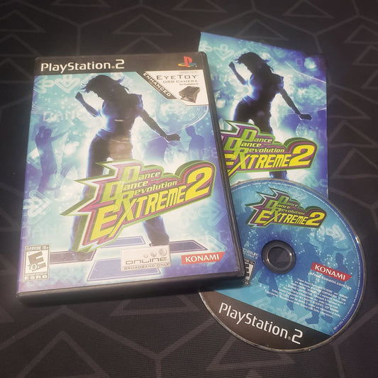 Image shows the case, manual and disc for the video game Dance Dance Revolution Extreme 2 for Playstation 2