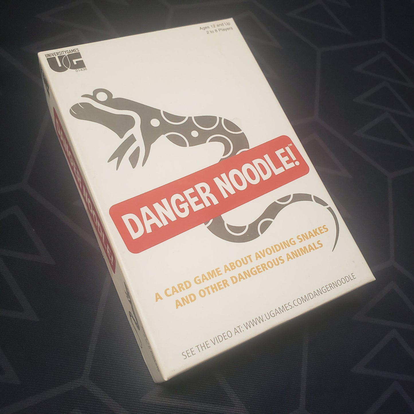 Image shows the front cover of the box for the Danger Noodle! card game