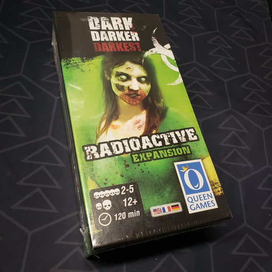 Image shows the front cover of the box of the Radioactive expansion for the board game Dark Darker Darkest