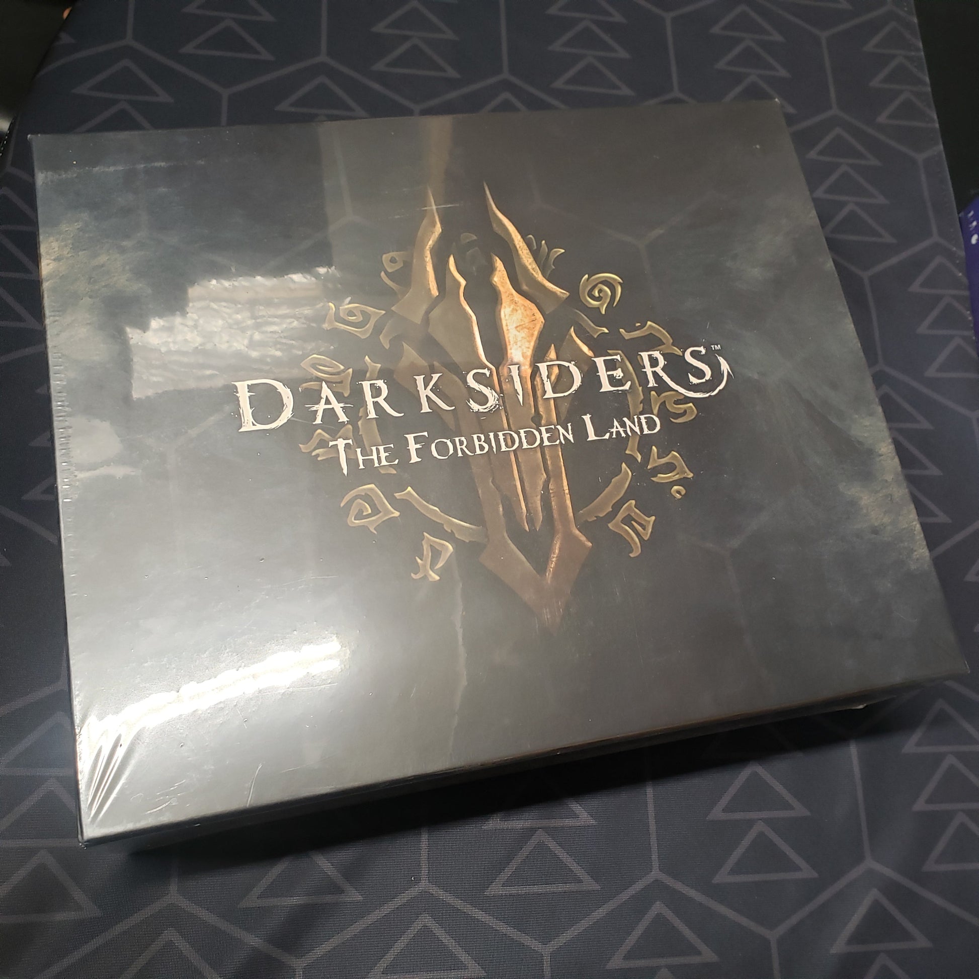 Image shows the front cover of the box for the Darksiders: The Forbidden Land board game