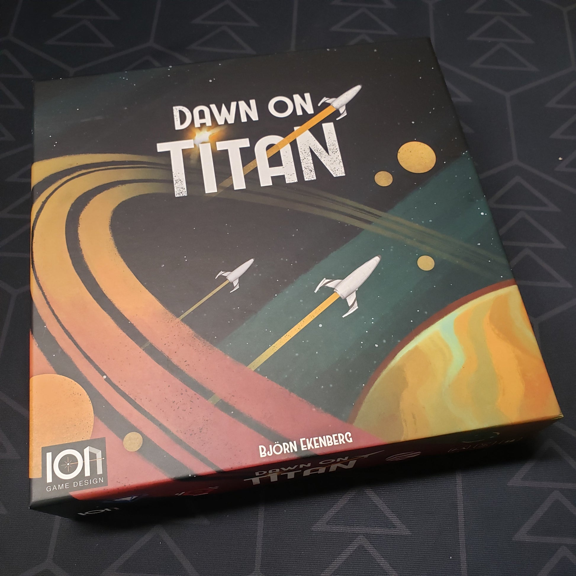 Image shows the front cover of the box for the Dawn on Titan board game