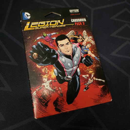 Image shows the front cover of the box of the Legion of Super-Heroes Crossover Pack expansion for the DC Comics Deckbuilding card game, along with the cards fanned out next to it