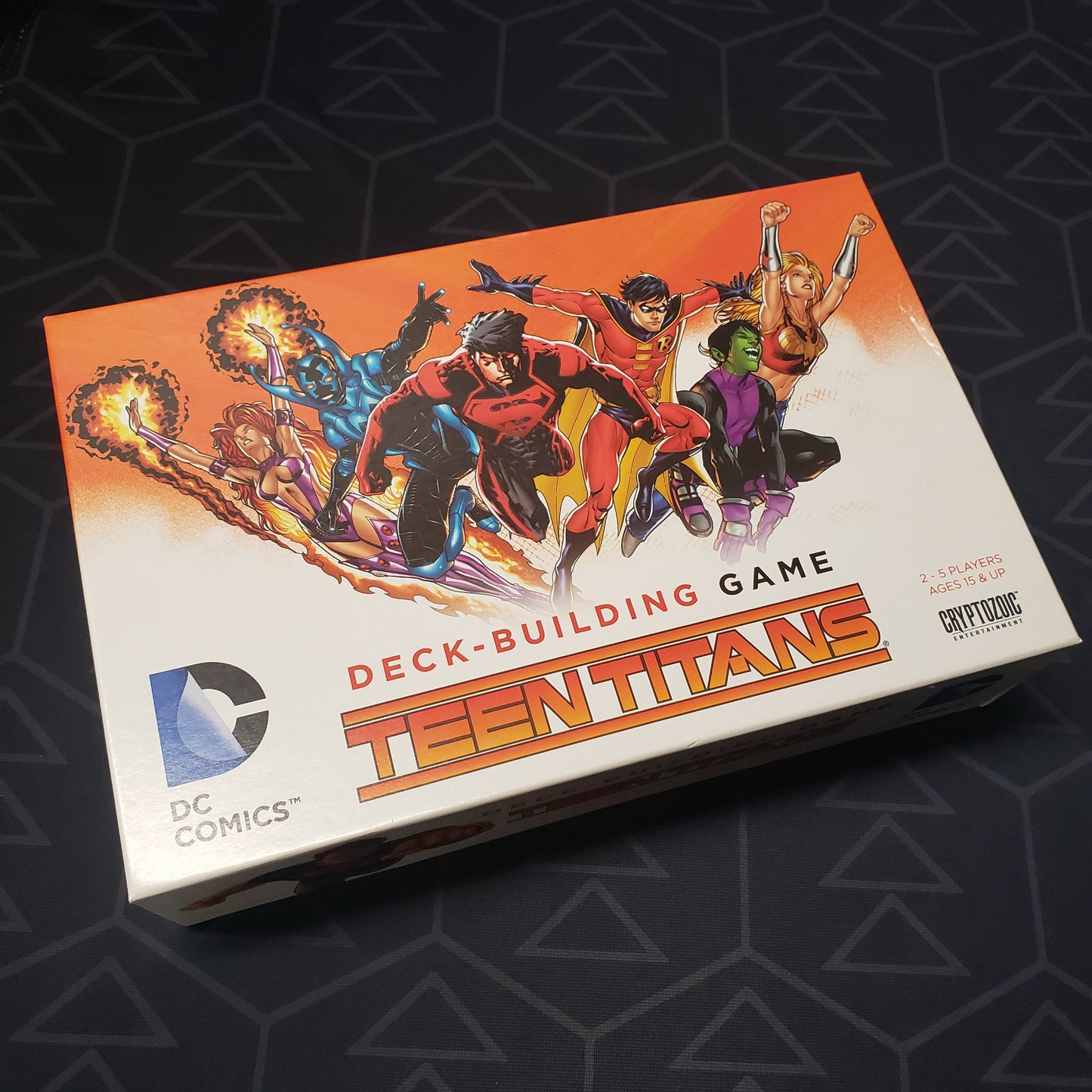 Image shows the front cover of the box for the DC Comics Deckbuilding Game: Teen Titans card game
