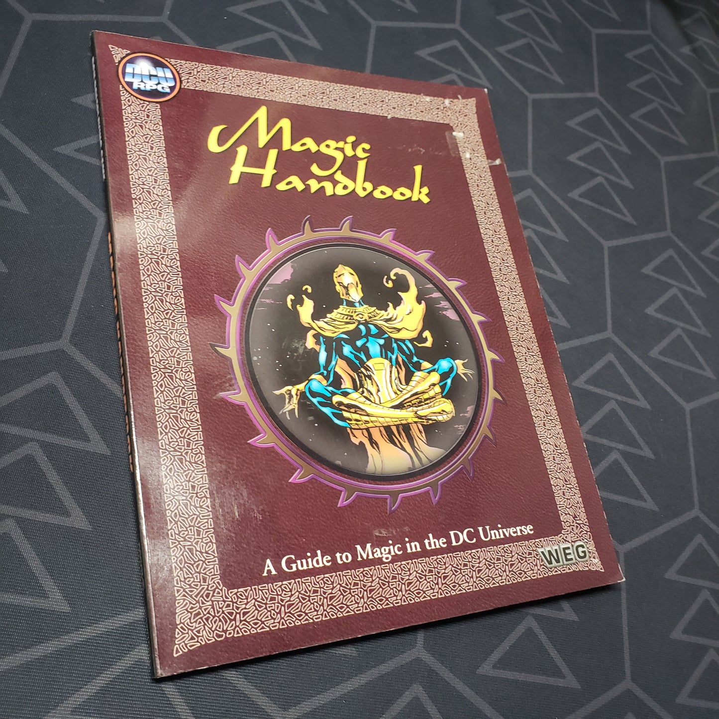 Image shows the front cover of the Magic Handbook book for the West End Games' roleplaying game DC Universe