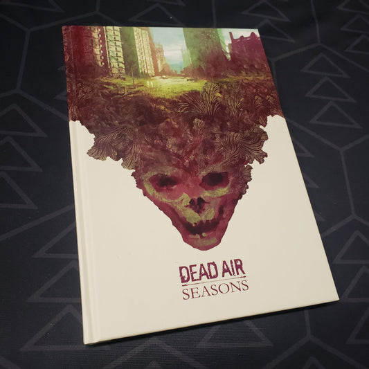 Image shows the front cover of the core rulebook for the roleplaying game Dead Air: Seasons