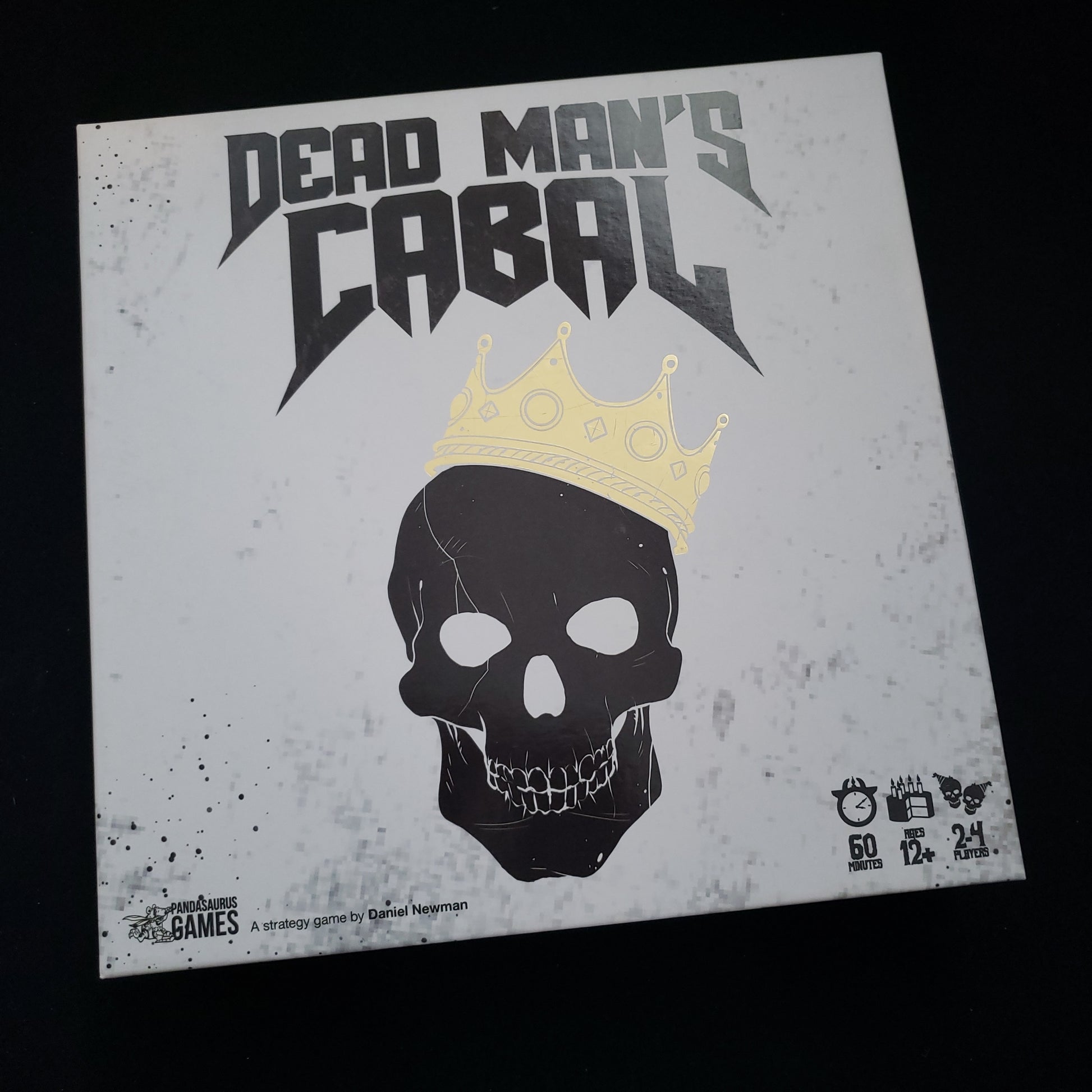 Image shows the front cover of the box of the Dead Man's Cabal board game