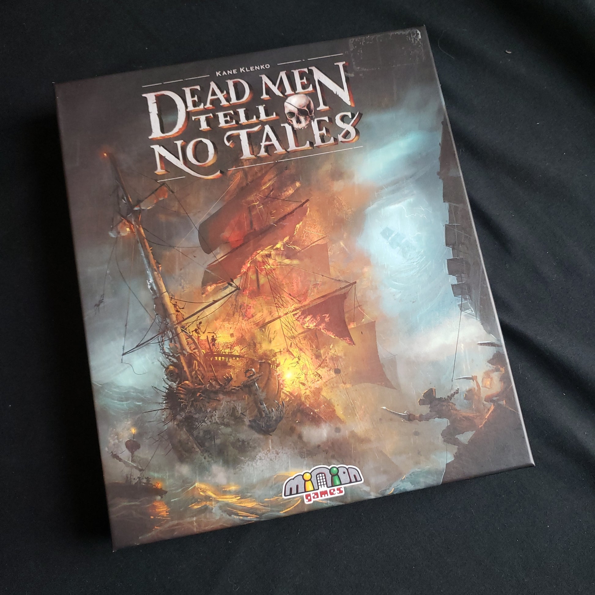 Image shows the front cover of the box of the Dead Men Tell No Tales board game