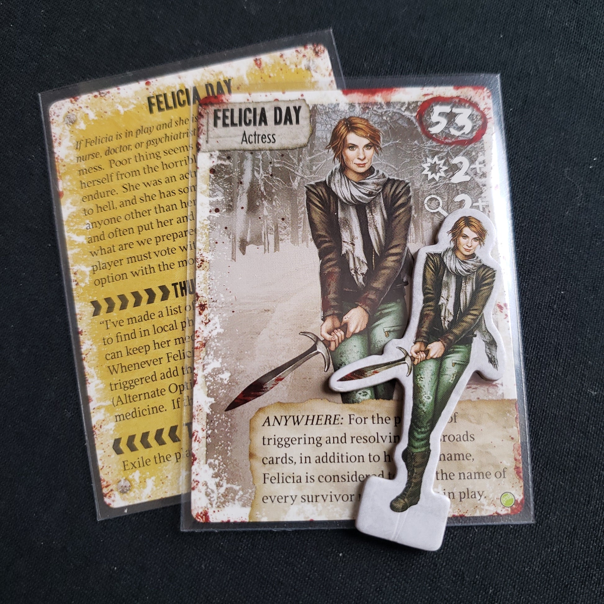 Image shows the two cards and standee for the Felicia Day promo for Dead of Winter