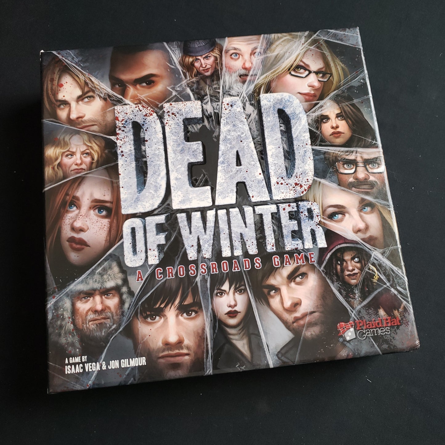 Image shows the front cover of the box of the Dead of Winter board game