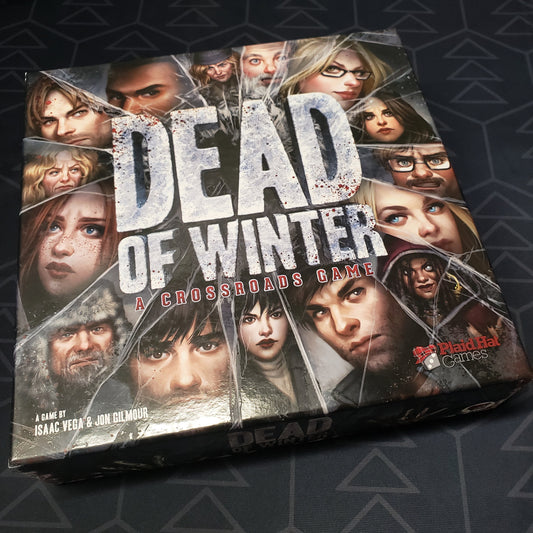 Image shows the front cover of the box of the Dead of Winter board game