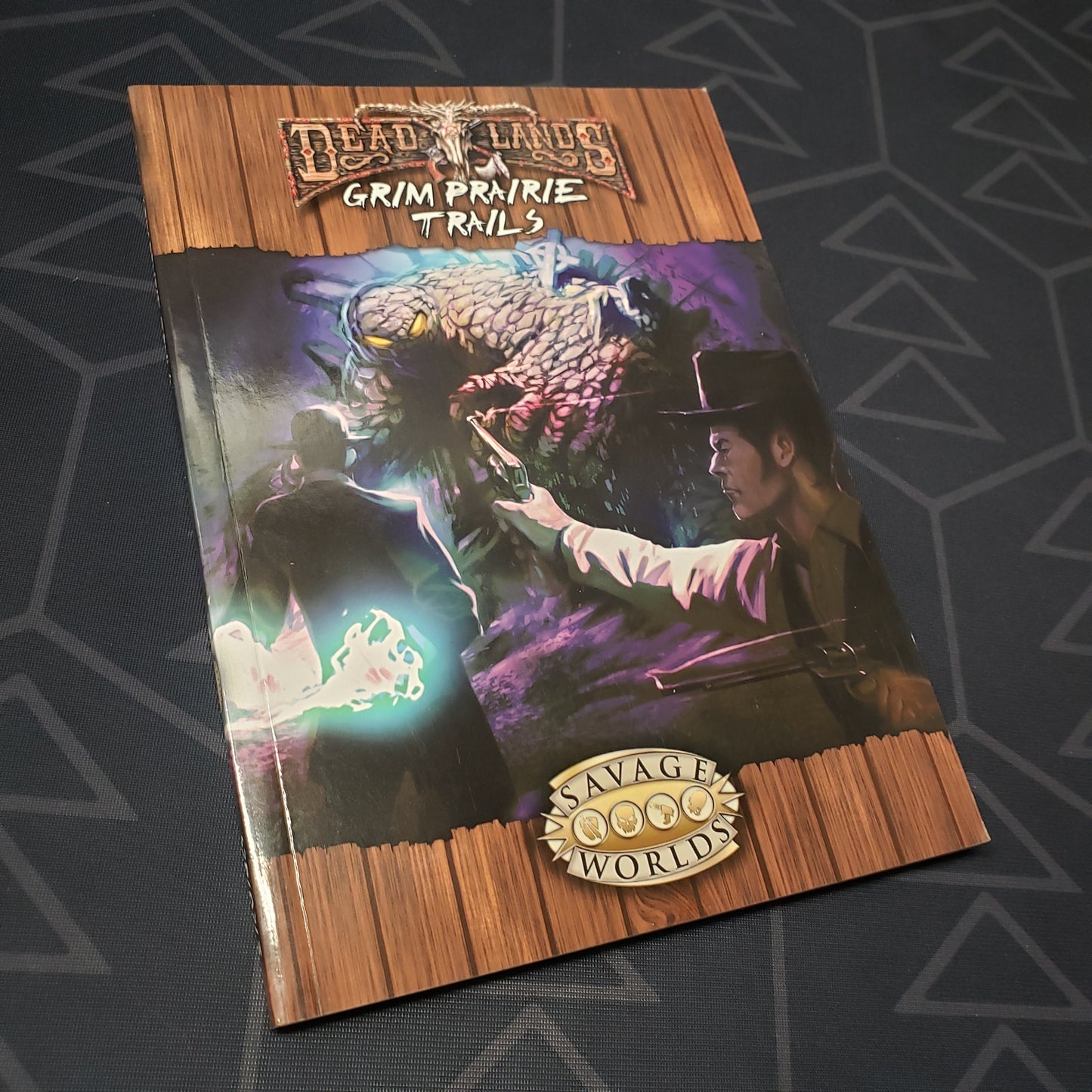 Image shows the front cover of the Grim Prairie Trails book for the roleplaying games Deadlands: Reloaded & Savage Worlds