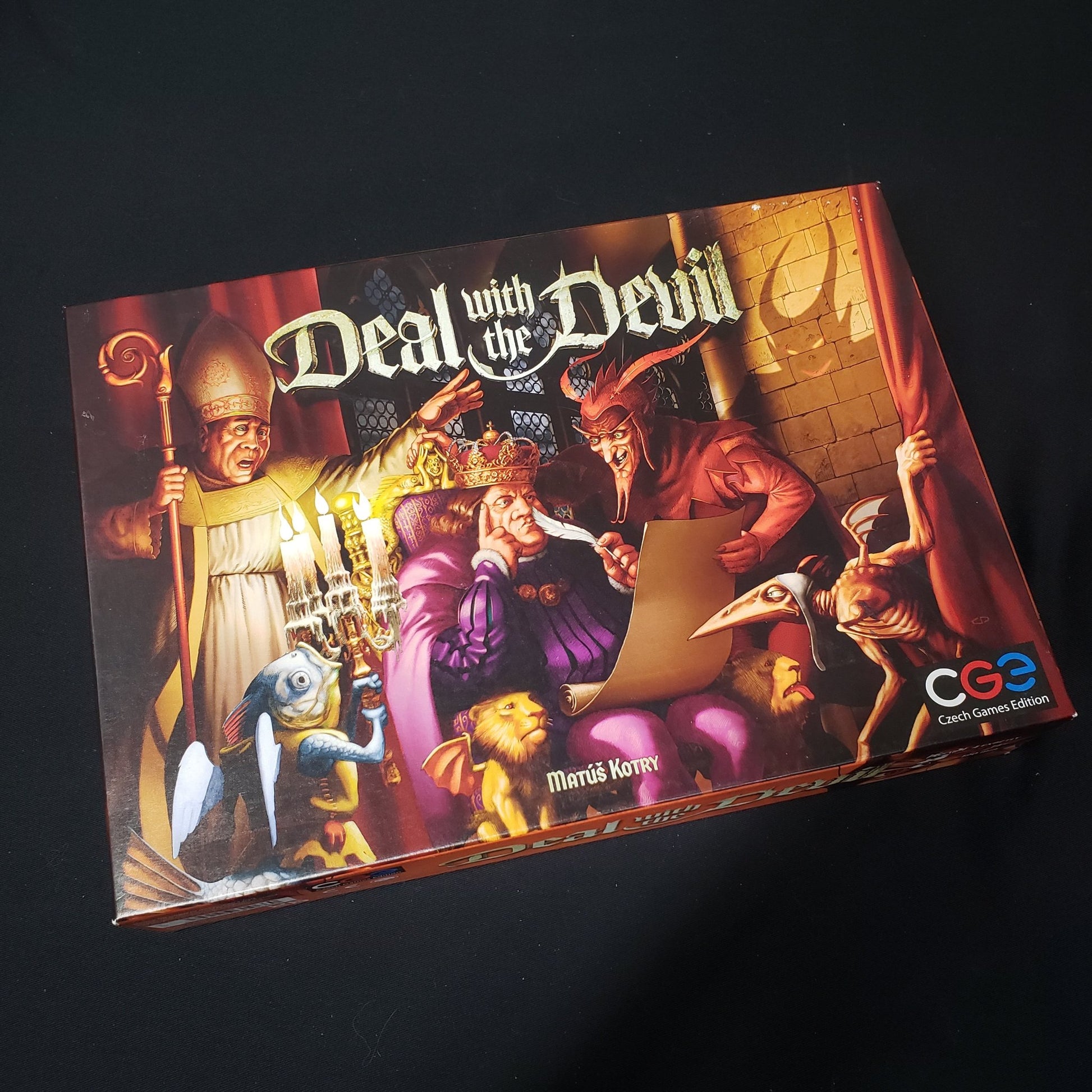 Image shows the front cover of the box of the Deal with the Devil board game