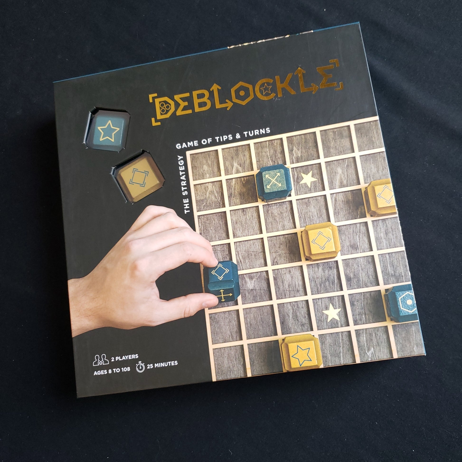 Image shows the front cover of the box of the Deblockle board game