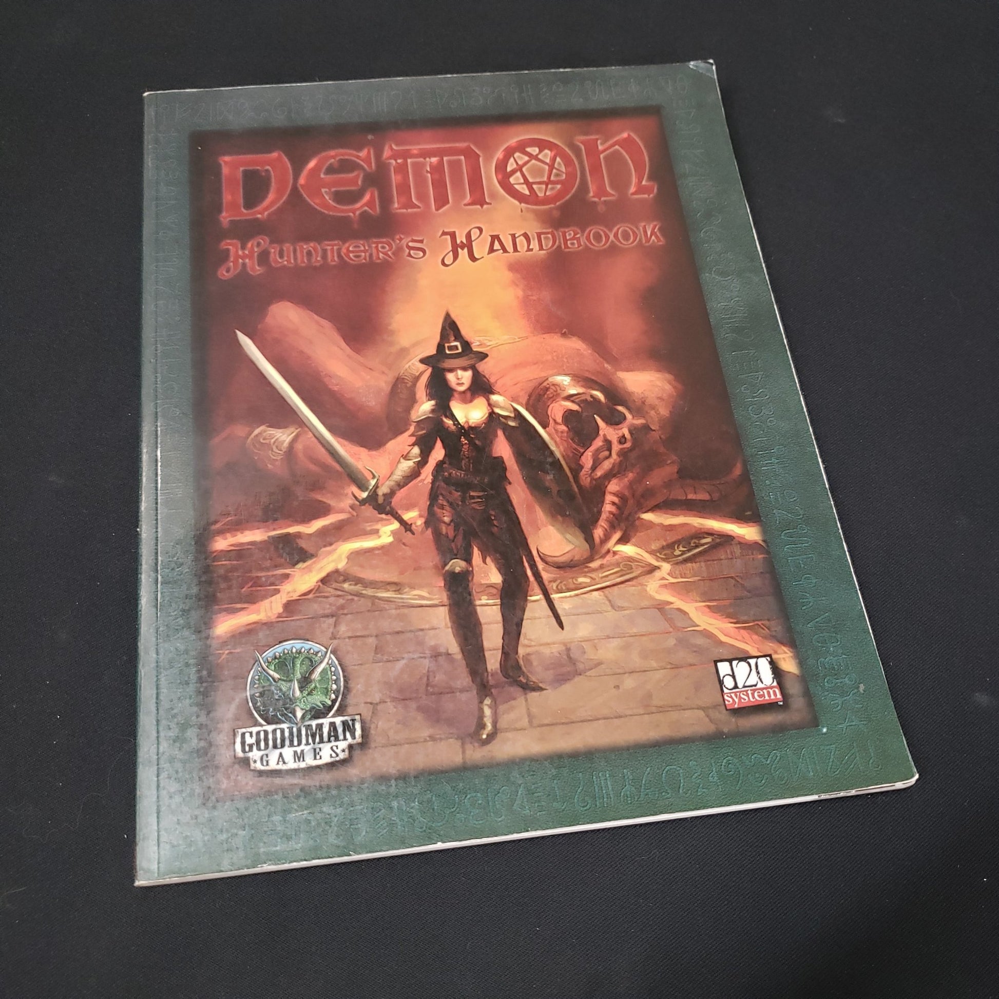 Image shows the front cover of the Demon Hunter's Handbook roleplaying game book