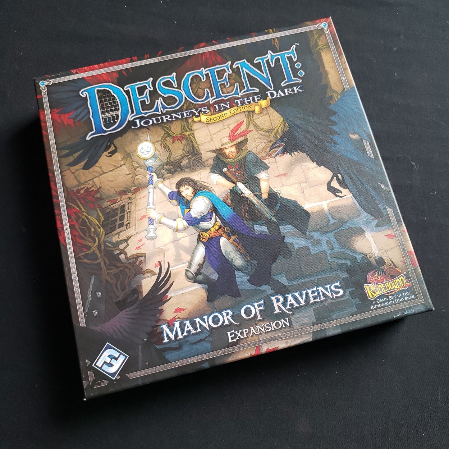 Image shows the front of the box for the Manor of Ravens Expansion for the Descent: Journeys in the Dark board game