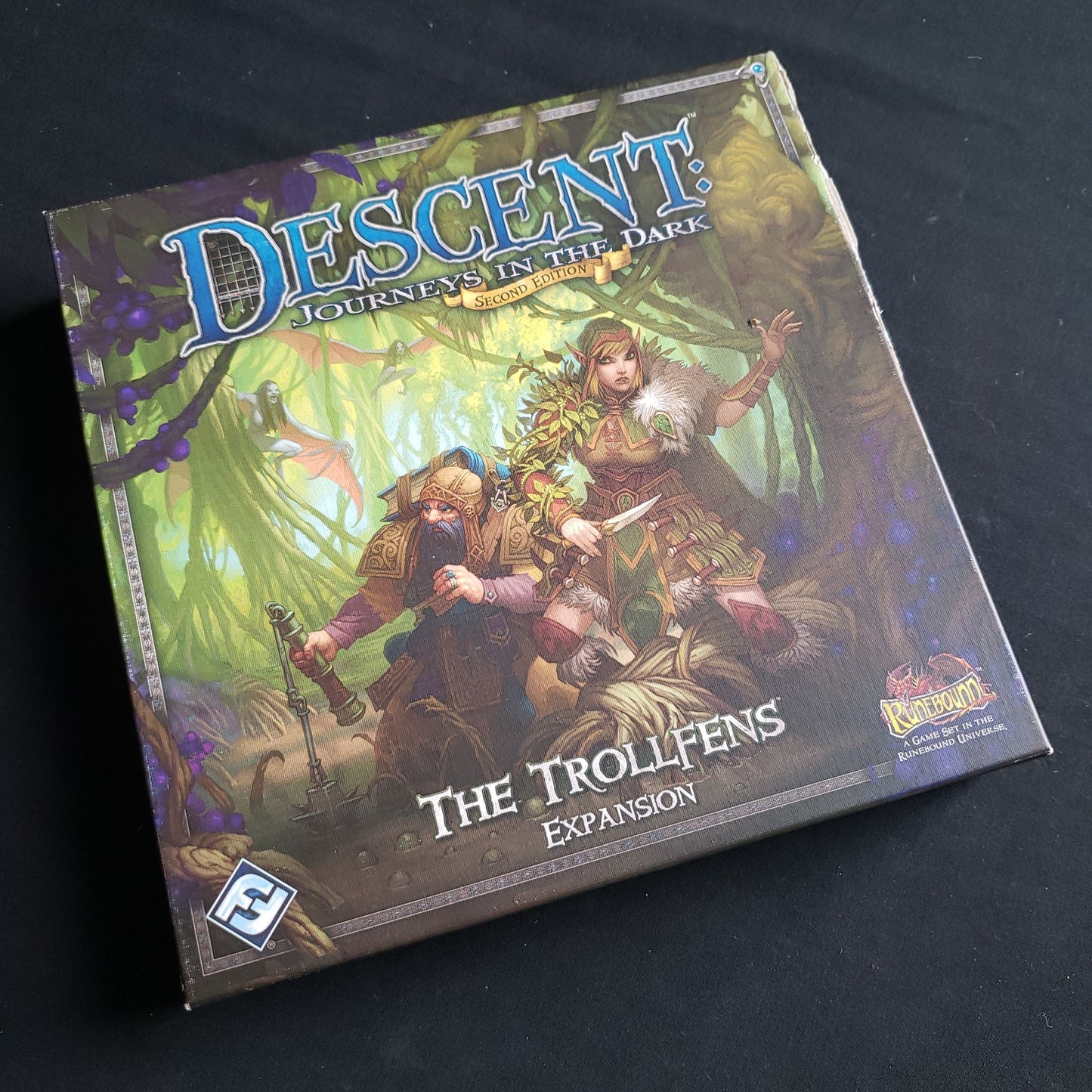 Image shows the front cover of the box of the Trollfens expansion for the board game Descent: Journeys in the Dark Second Edition