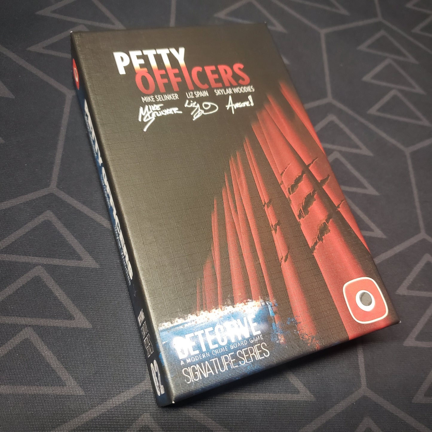 Image shows the front cover of the box of the Signature Series: Petty Officers expansion for the board game Detective