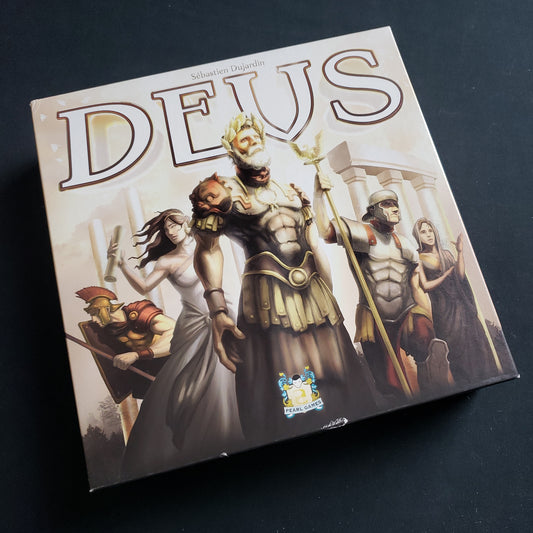 Image shows the front cover of the box of the Deus board game