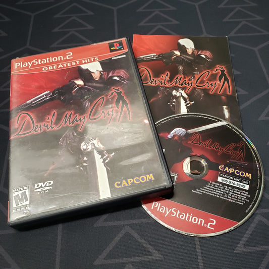 Image shows the case, manual and disc for the video game Devil May Cry for Playstation 2