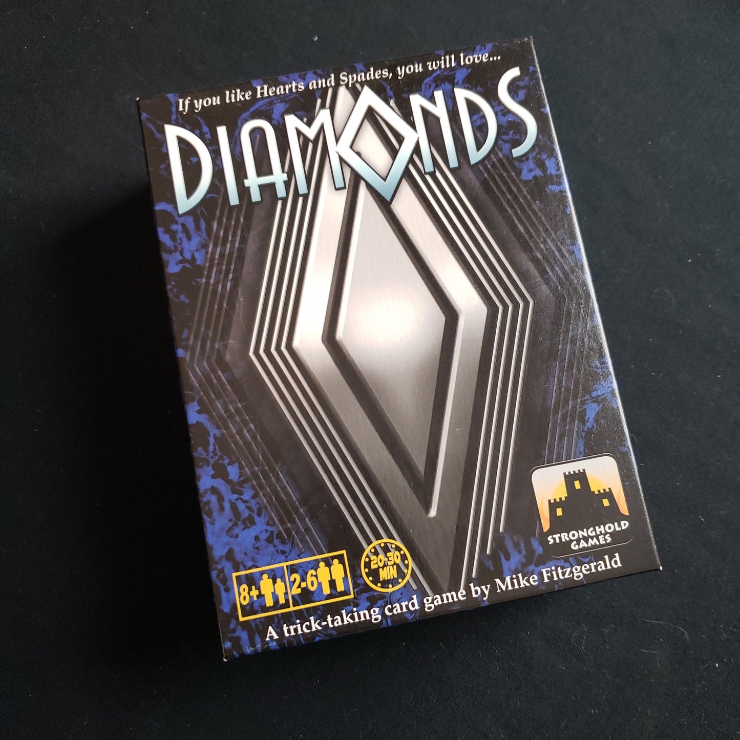 Image shows the front cover of the box of the Diamonds card game