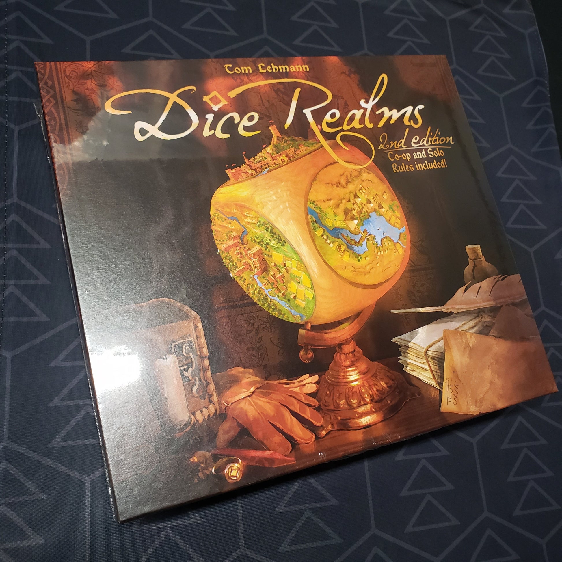Image shows the front cover of the box for the Dice Realms board game