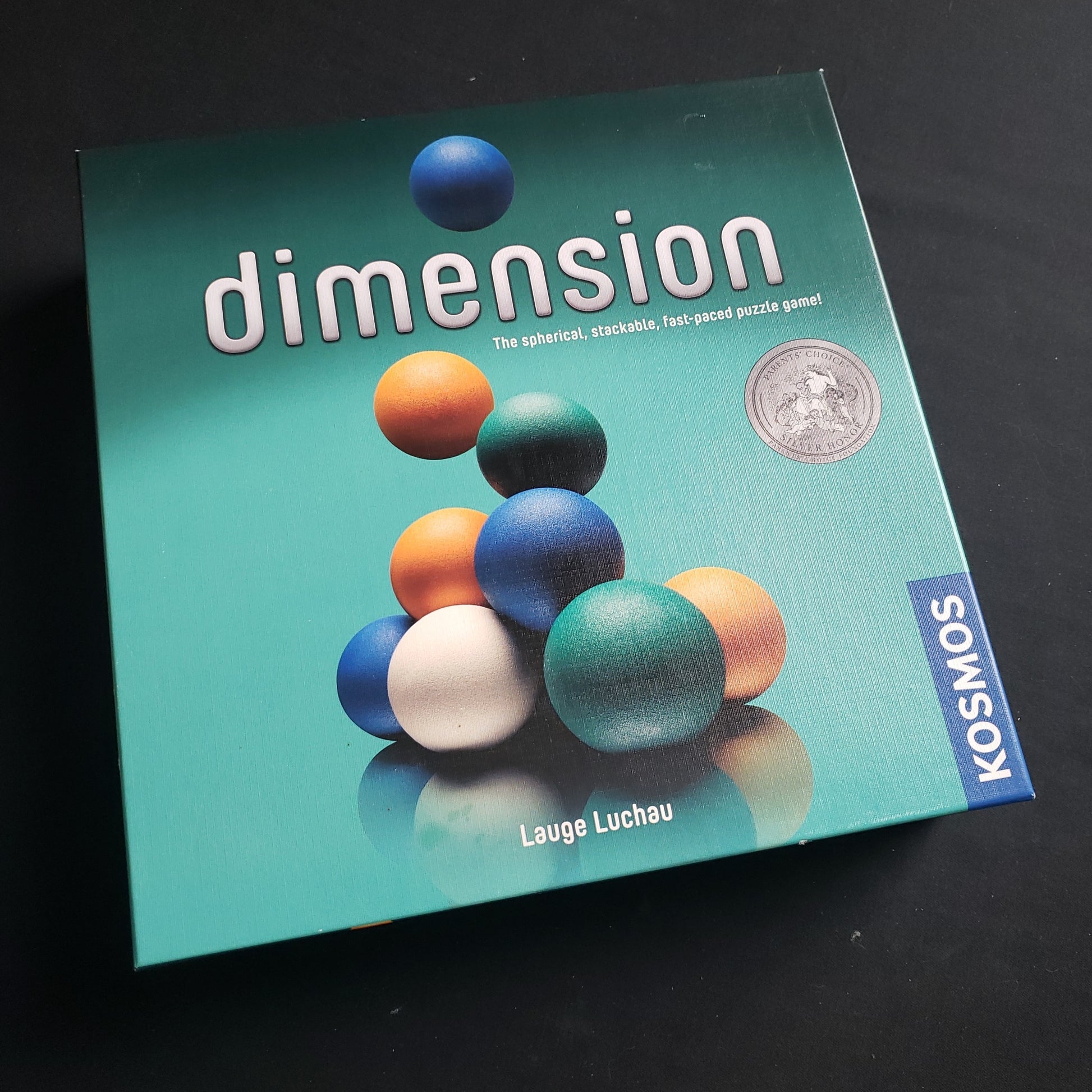 Image shows the front cover of the box of the Dimension board game