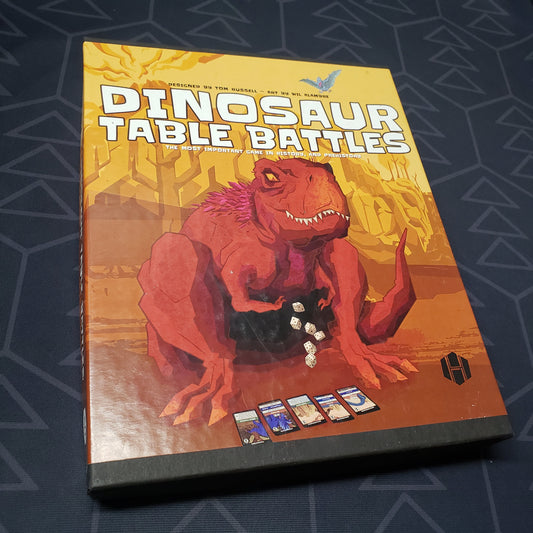 Image shows the front cover of the box for the Dinosaur Table Battles board game