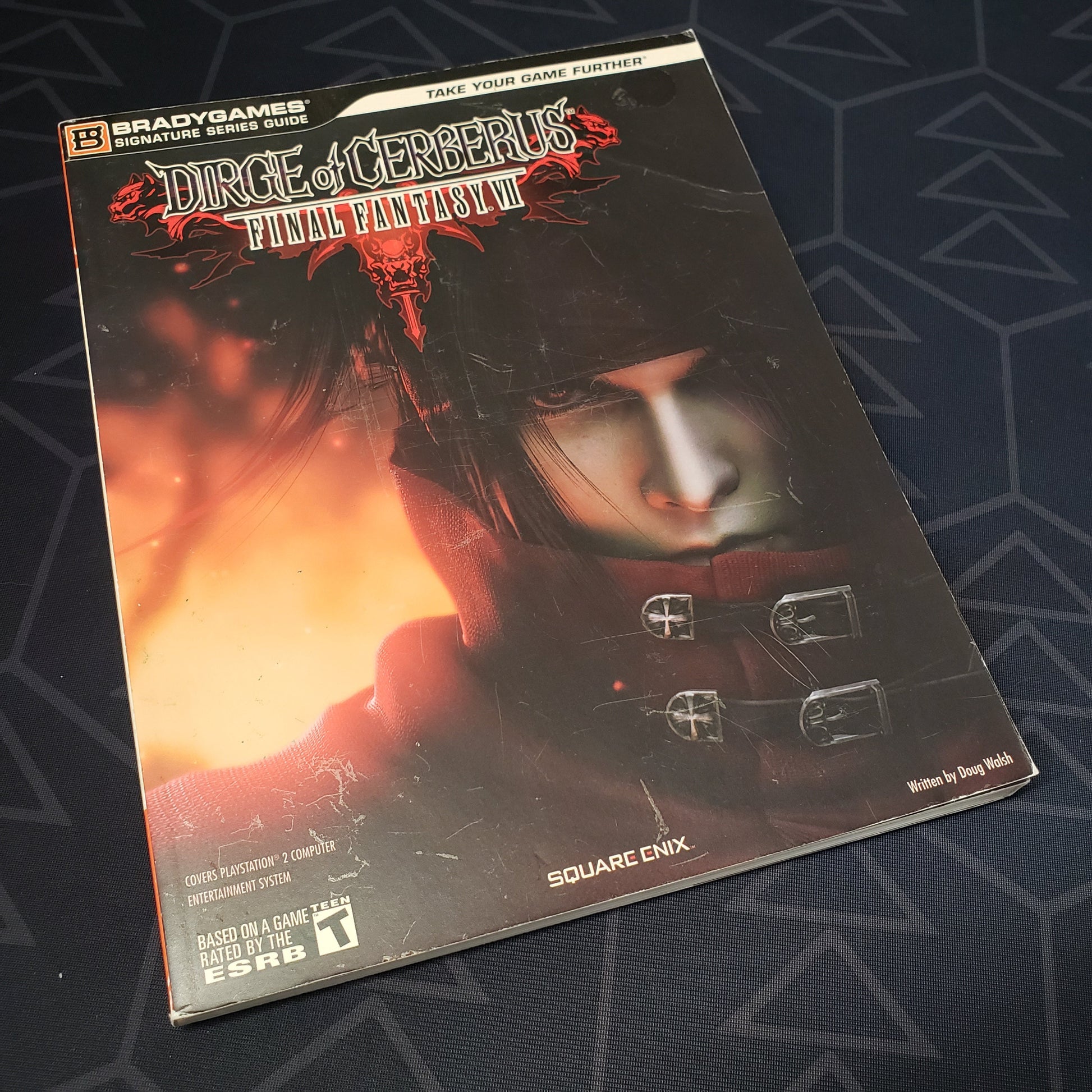 Image shows the front cover of the strategy guide for the game Dirge of Cerberus: Final Fantasy VII
