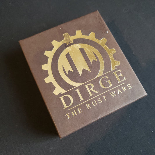 Image shows the front cover of the box of card game Dirge: The Rust Wars