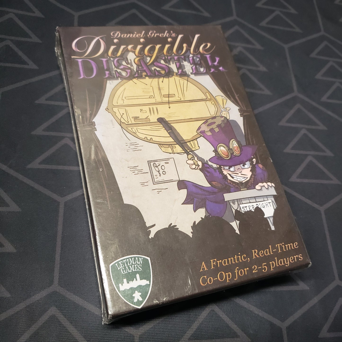 Image shows the front cover of the box for the Dirigible Disaster board game