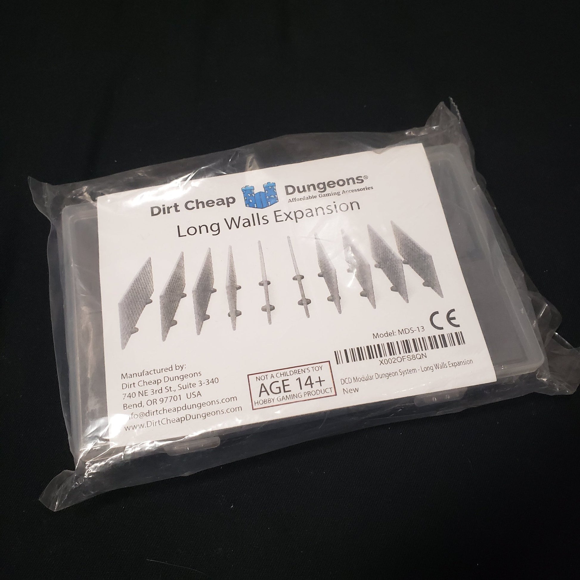 Image shows the front of the packaging of the Long Walls Expansion set for the Dirt Cheap Dungeons modular terrain system