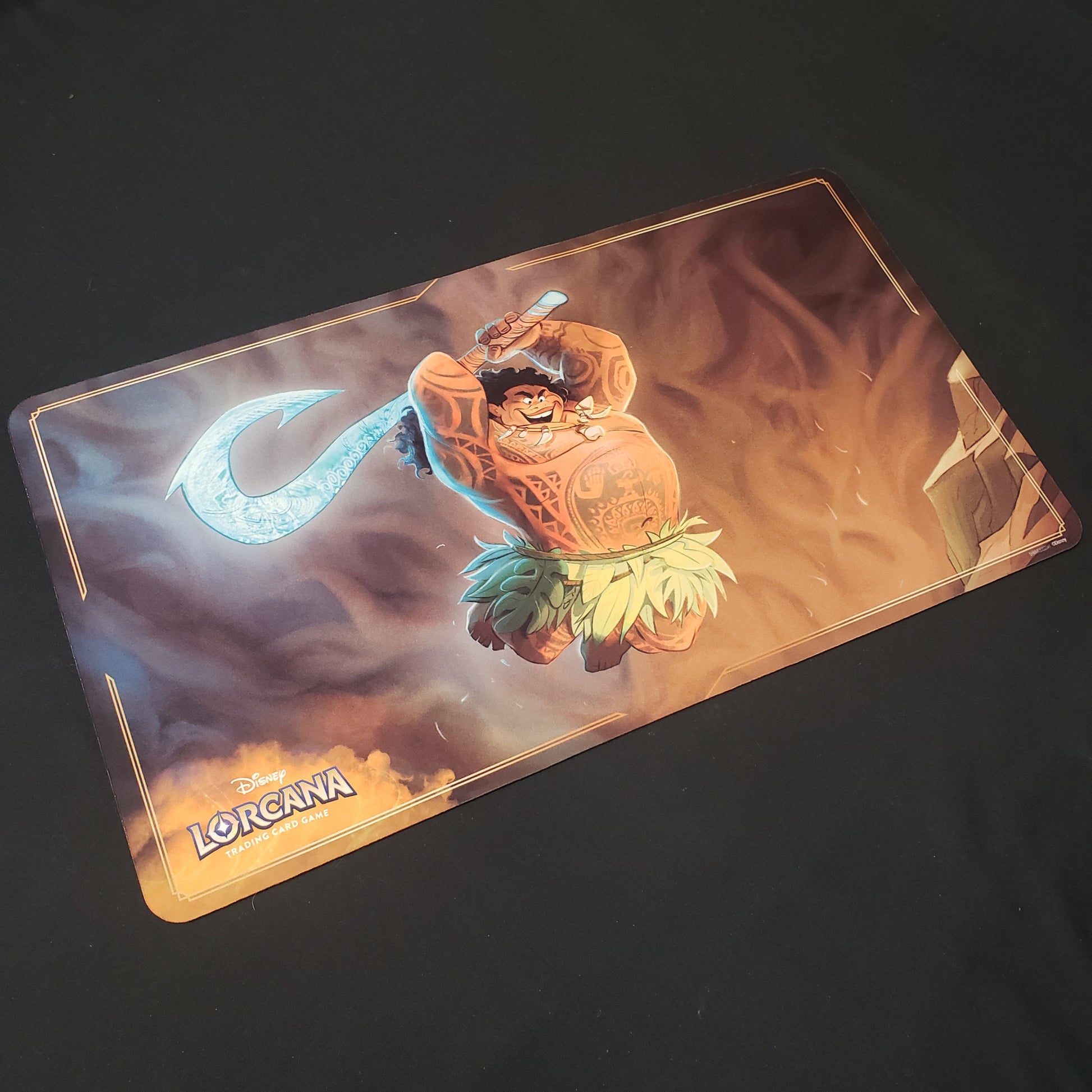 Image shows a playmat featuring First Chapter: Maui, Just in Time art for the Disney Lorcana card game