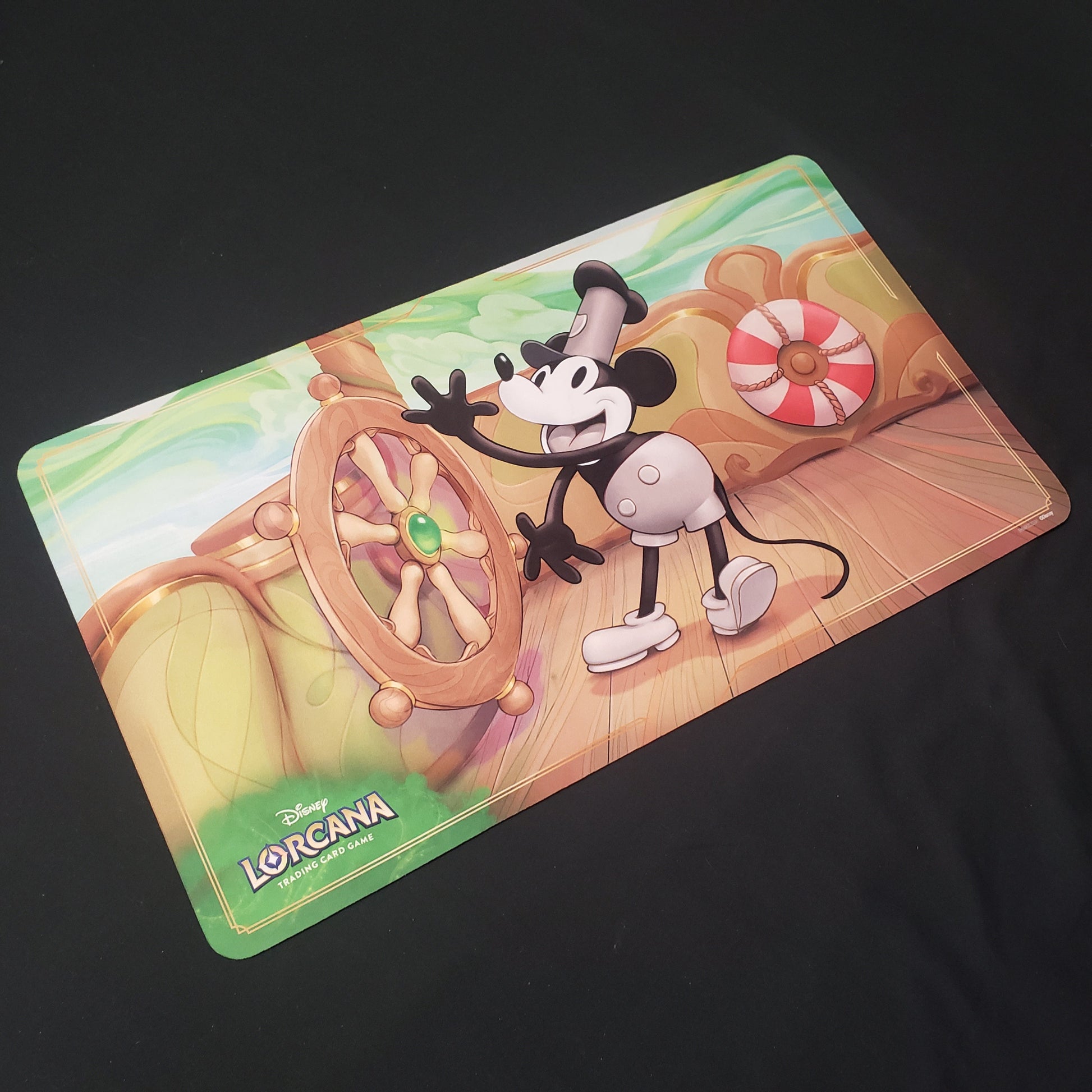Image shows a playmat featuring First Chapter: Steamboat Willie art for the Disney Lorcana card game