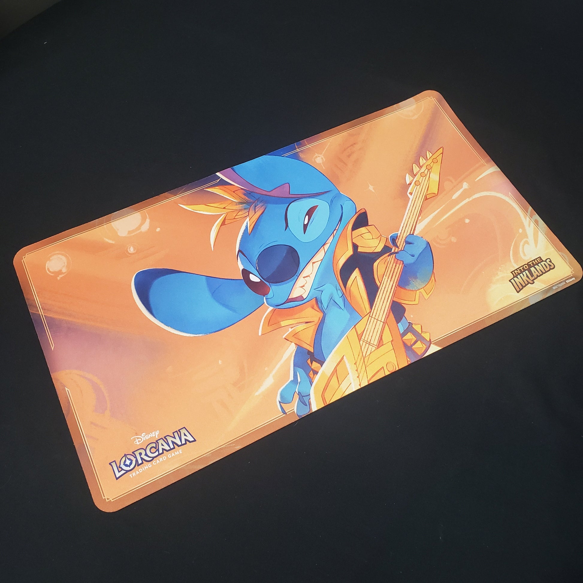 Image shows a playmat featuring Into the Inklands: Stitch, Rock Star art for the Disney Lorcana card game