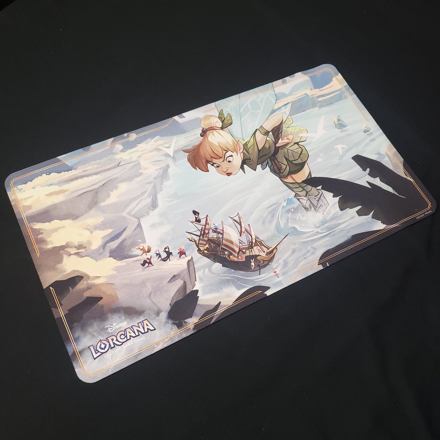 Image shows a playmat featuring Ursula's Return: Tinkerbell art for the Disney Lorcana card game