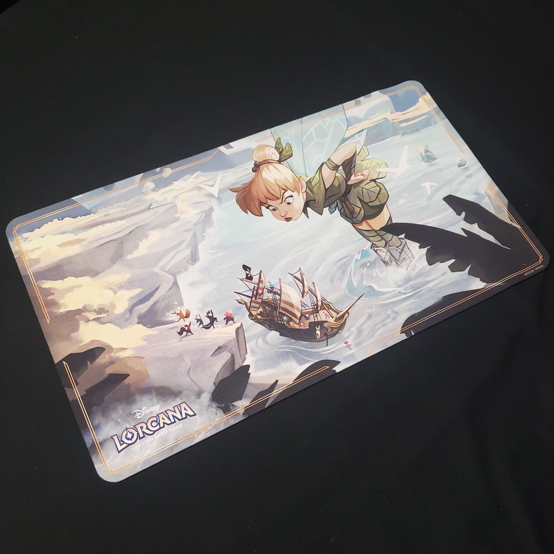 Image shows a playmat featuring Ursula's Return: Tinkerbell art for the Disney Lorcana card game