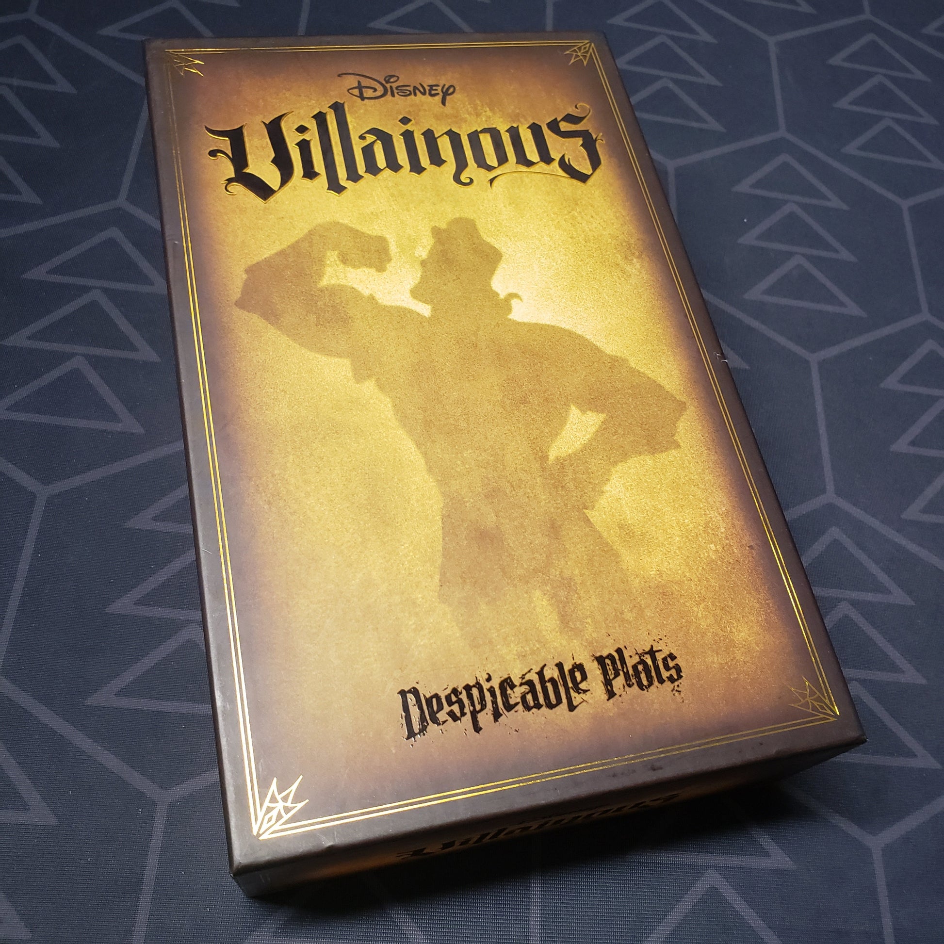 Image shows the front cover of the box for the Disney Villainous: Despicable Plots card game
