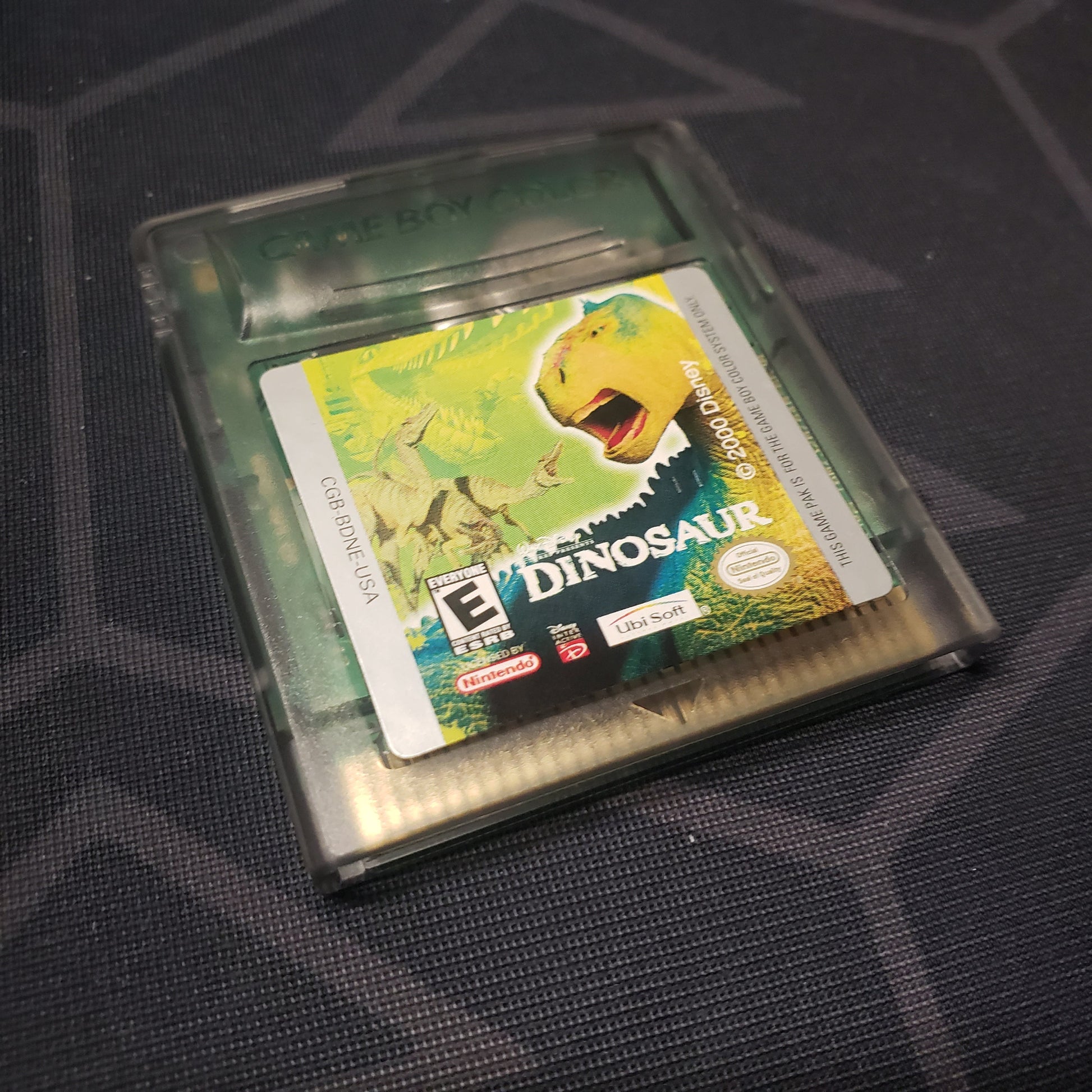 Image shows the front of the cartridge for the video game Disney's Dinosaur for Nintendo Game Boy Color