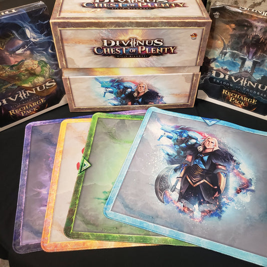 Image shows the box of the Chest of Plenty for the board game Divinus, surrounded by extra upgrades included with it