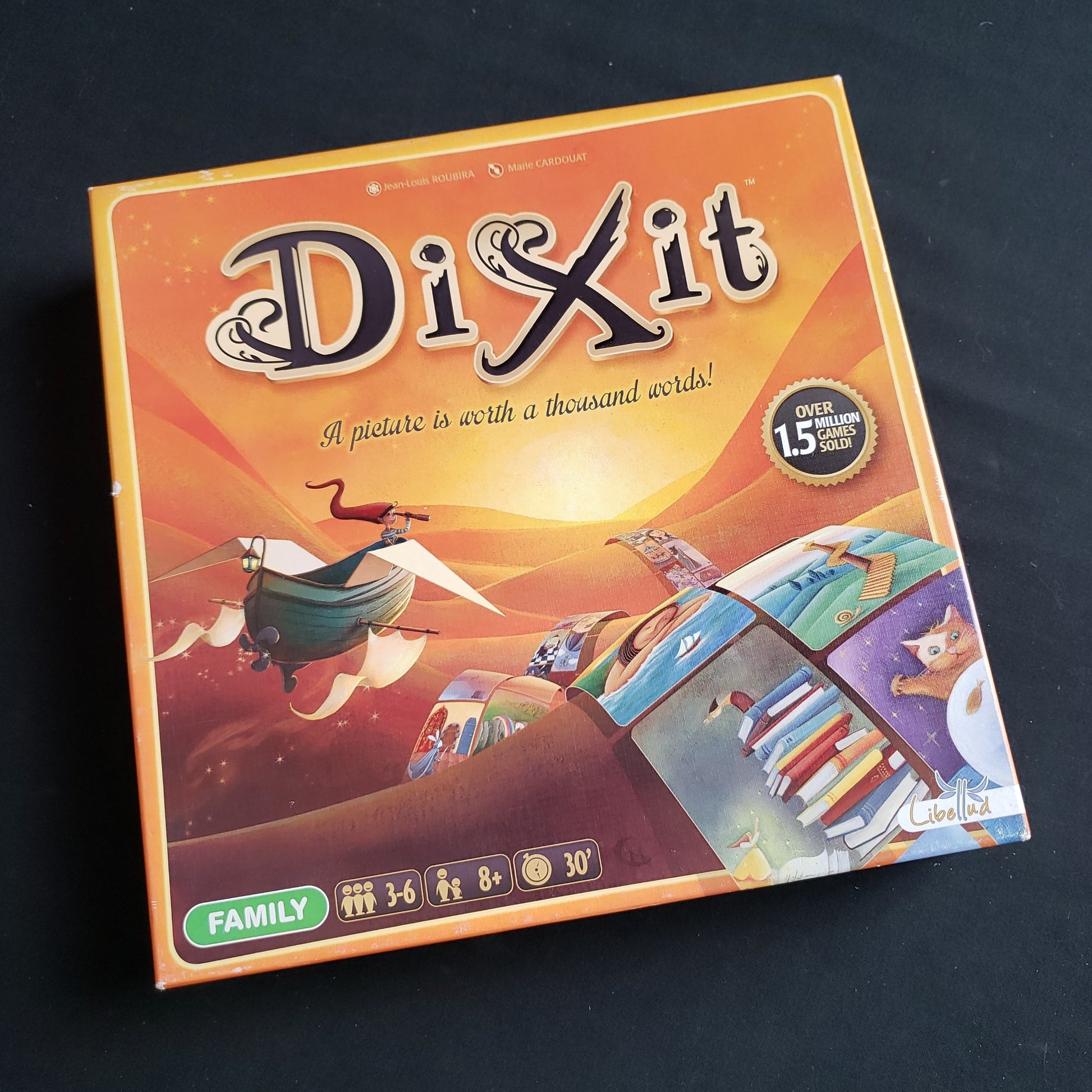 Image shows the front cover of the box of the Dixit board game